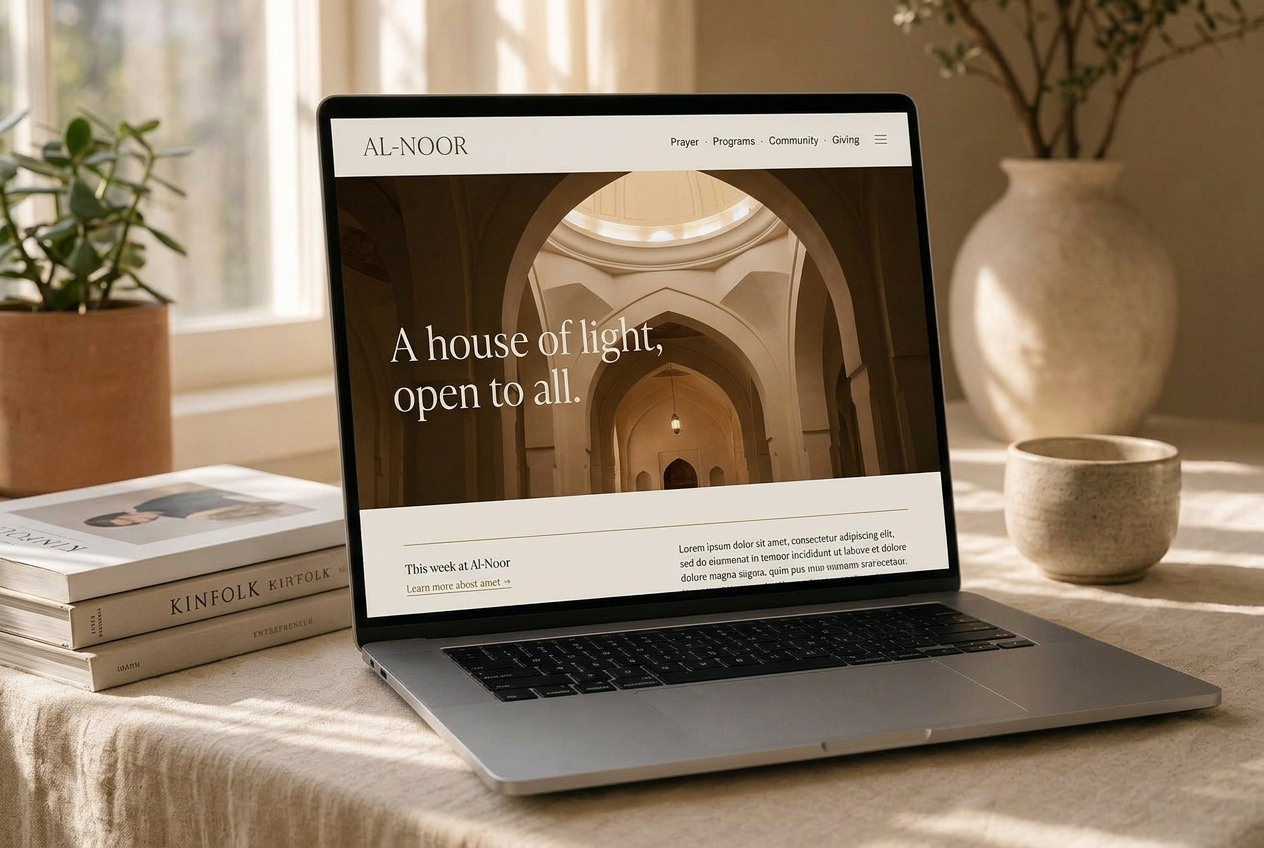Al-Noor Masjid website shown on an angled laptop in warm window light